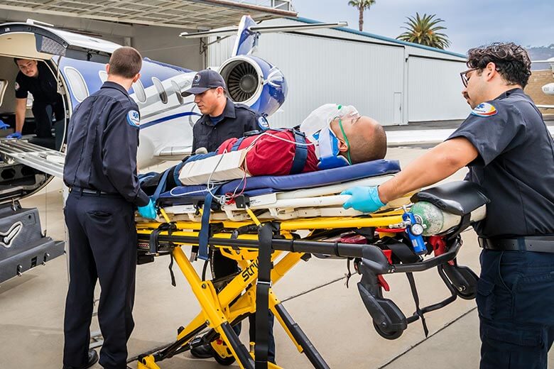img-air-ambulance-3 air ambulance workers loading patient into plane
